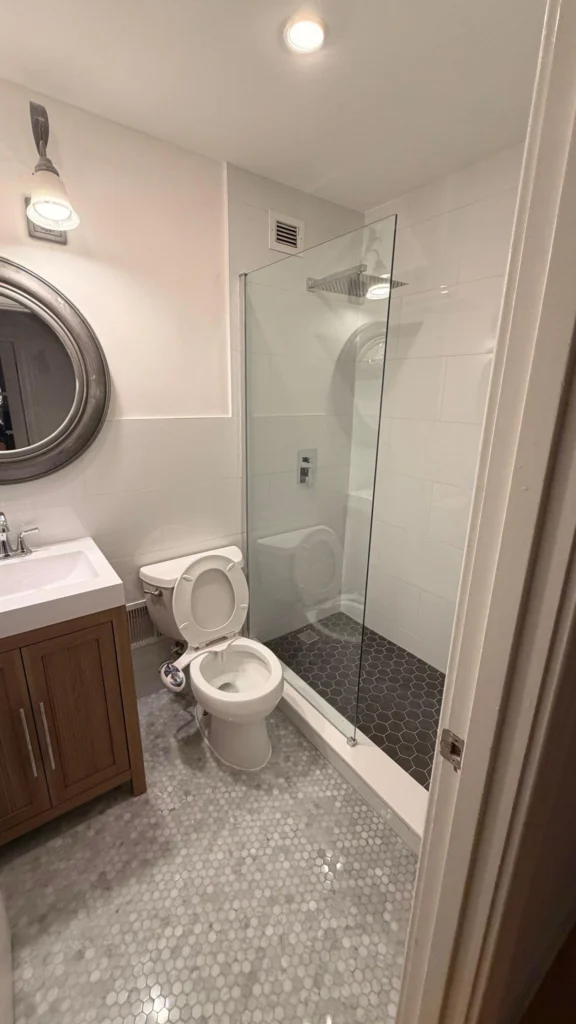 Narrow bathroom after a full remodel with new shower and fixtures