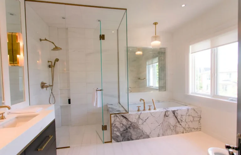 Marble bathroom remodel with glass shower enclosure and soaking tub