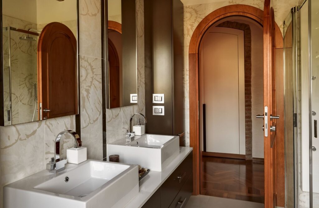 Remodeled bathroom with twin vessel sinks and custom millwork