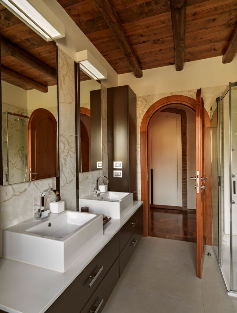 Double-sink vanity and arched doorways in a completed bathroom remodel