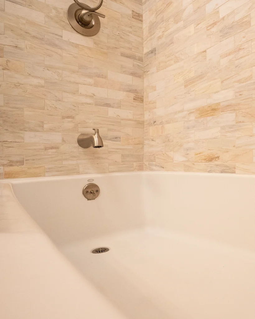 Soaking tub with natural stone tile surround
