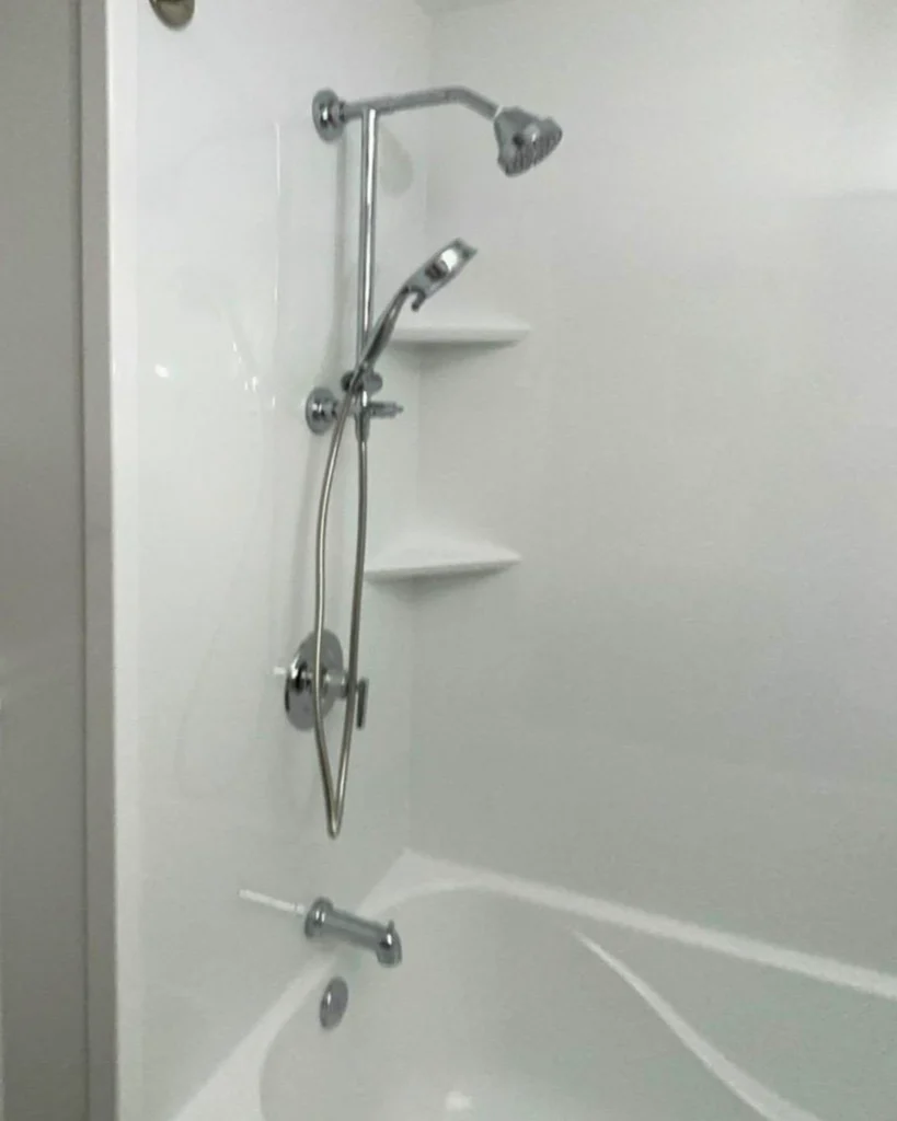 Tub and shower combo with sliding handheld shower bar